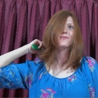 combing her hair before her head shaving video